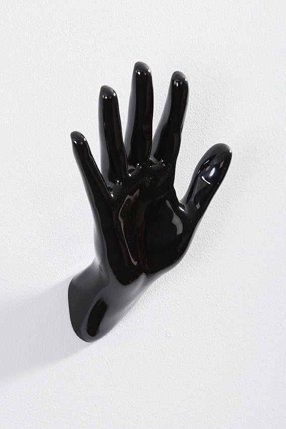 Hand wall art or hook, waving gesture, and black colour