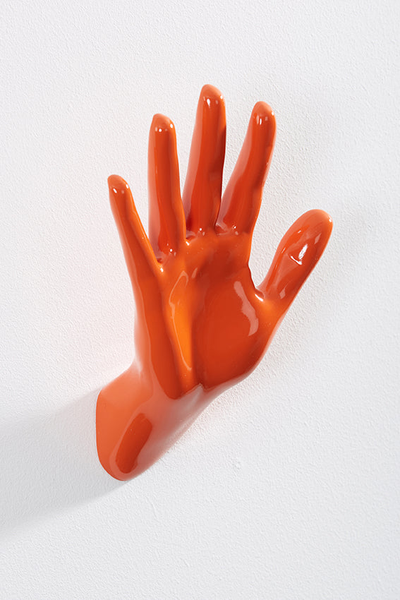 Hand wall art or hook, waving gesture, and orange colour