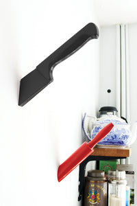 Black knife hook, red rolling pin hook on wall