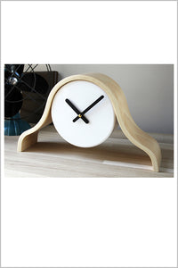 Wood frame, white mantel clock, black hands, on shelf